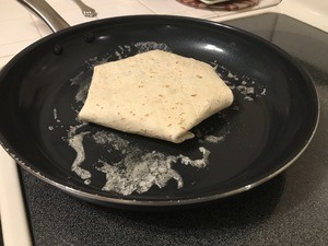 Place crunchwrap in frying pan for a minute or two.