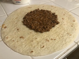 Place ground beef in center of tortilla